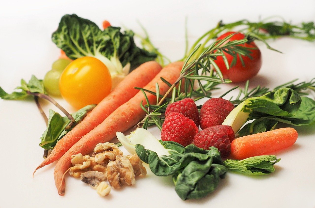 Fresh fruits and vegetables against a white background.